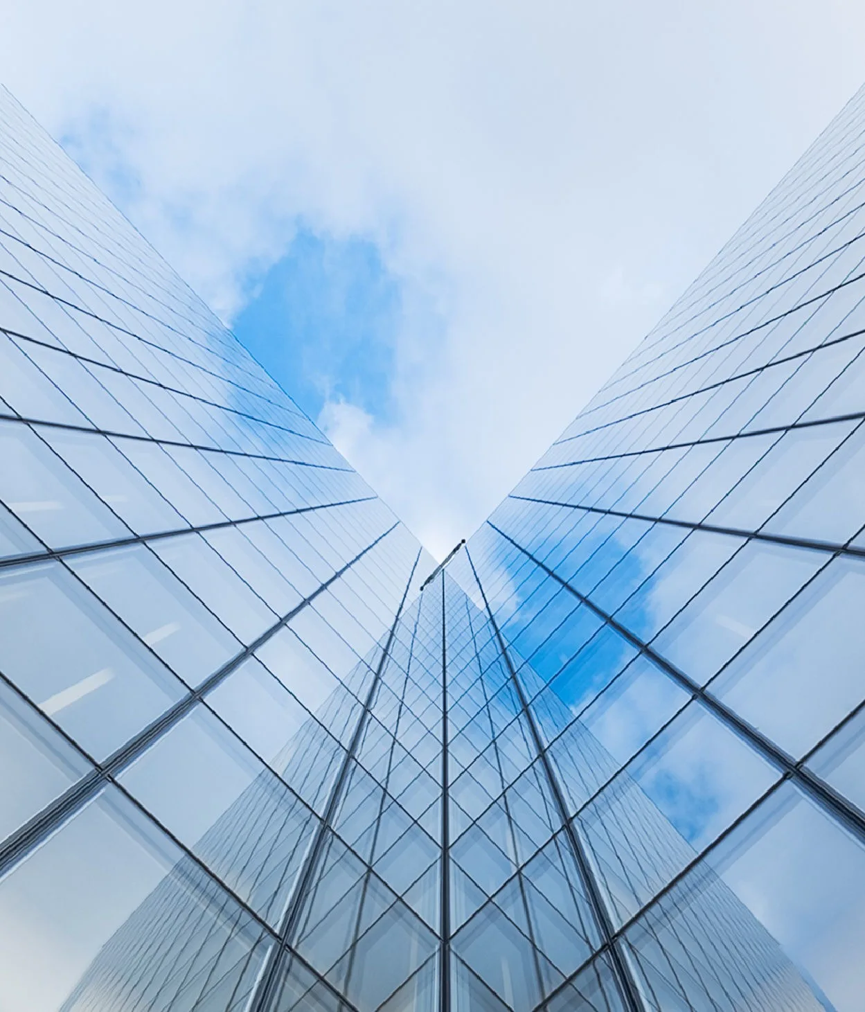 Low angle shot looking up at an angled office building.