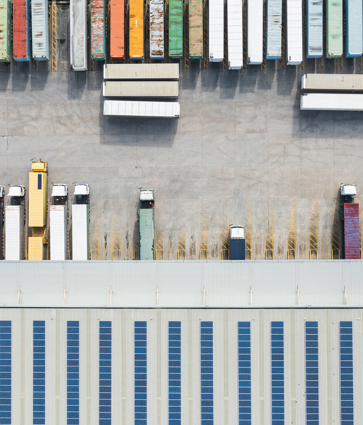 Aerial photo of supply trucks and containes at a distrubution facility.